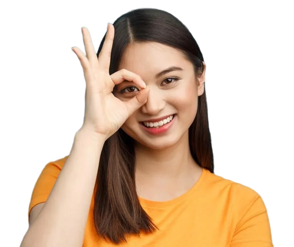 Happy young woman making okay sign with hand over eye, smiling playfully